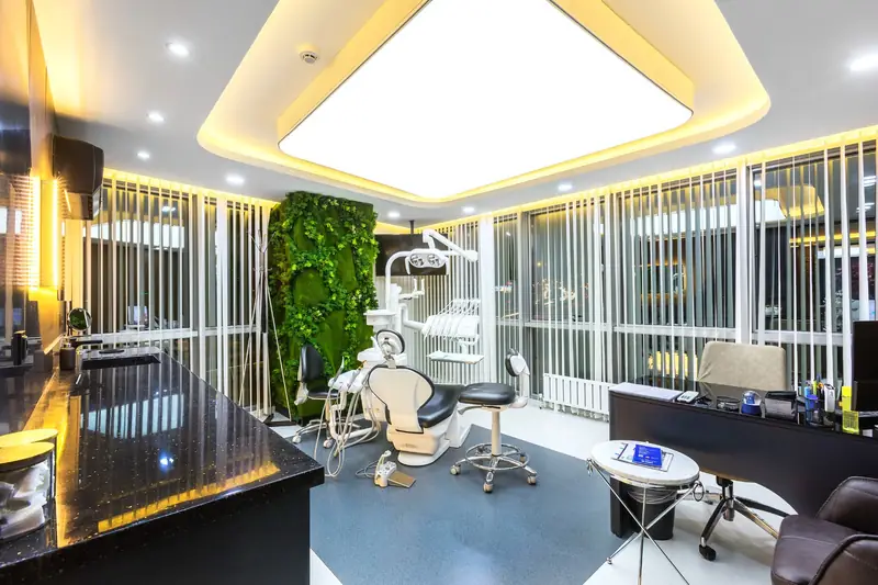 Treatment room with dental chair and plant wall